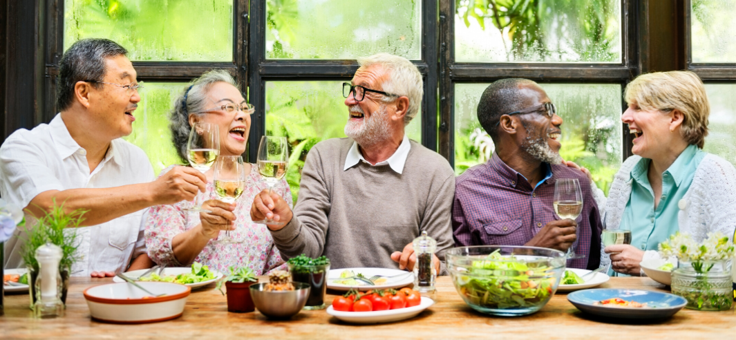 Image of older adults gathering at the table for a meal.